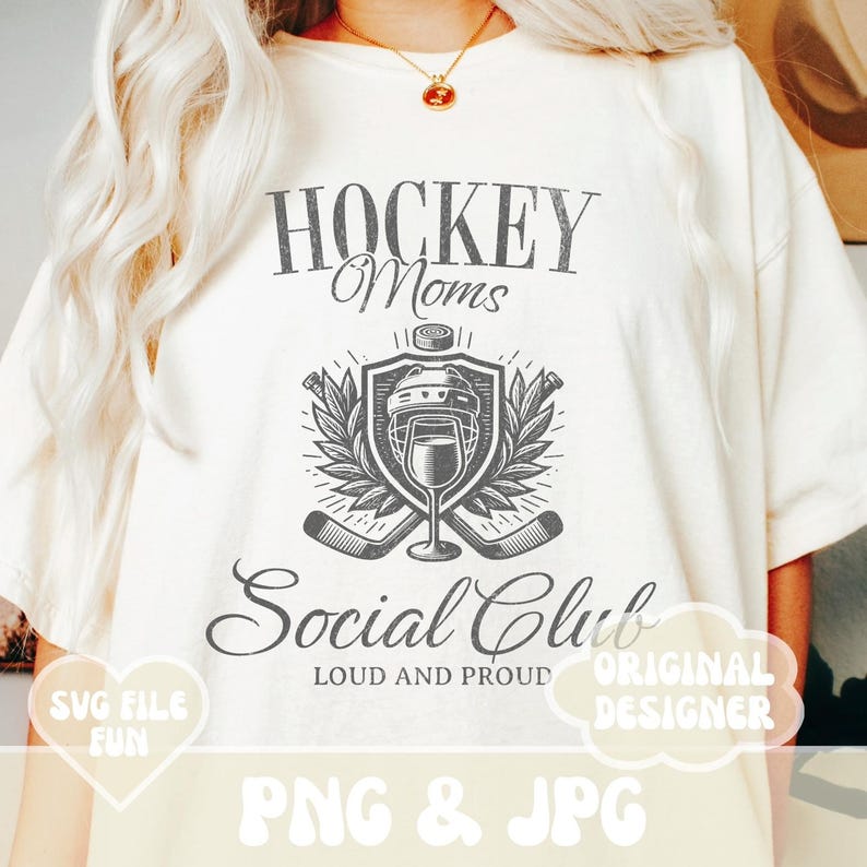 May include: A white t-shirt with a black and white graphic design that says "Hockey Moms Social Club Loud and Proud". The graphic features a hockey helmet, hockey sticks, and a wine glass.