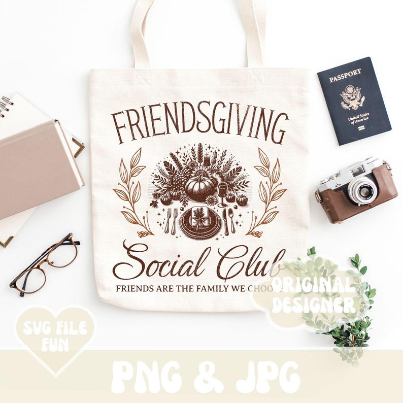 May include: A cream-colored tote bag with the words "FRIENDSGIVING Social Club" in brown script. The bag features a fall-themed graphic with a pumpkin, leaves, and cutlery. A passport, camera, and glasses are also visible.