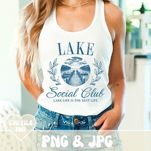 May include: White tank top with a blue graphic design that says "LAKE Social Club LAKE LIFE IS THE BEST LIFE".