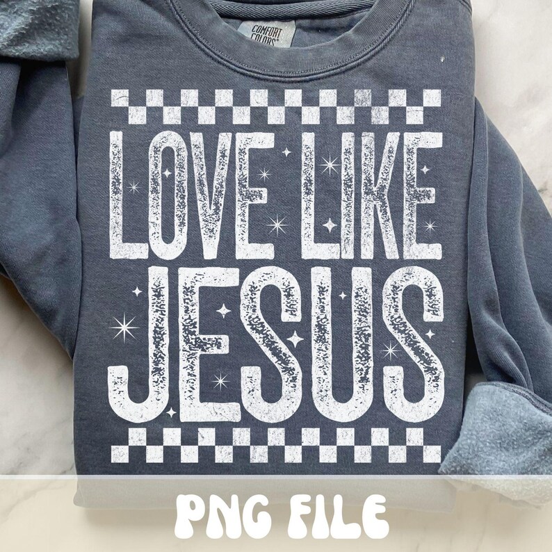 K&ouml;nnte beinhalten: Ein graues Sweatshirt mit dem wei&szlig;en Text "LOVE LIKE JESUS", eingerahmt von einem Schachbrettmuster. Das Sweatshirt mit Rundhalsausschnitt hat lange &Auml;rmel. Die Worte "PNG FILE" sind unten im Bild zu sehen.