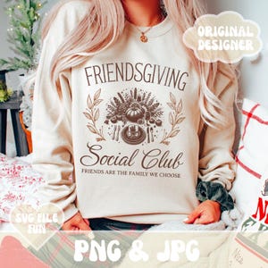 May include: Beige Friendsgiving Social Club sweatshirt with a brown graphic of a Thanksgiving feast. The text "FRIENDSGIVING Social Club" and "FRIENDS ARE THE FAMILY WE CHOOSE" are printed on the front. The image also includes the text "ORIGINAL DESIGNER", "SVG FILE FUN", and "PNG & JPG".