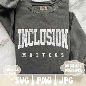 May include: A gray sweatshirt with the text "INCLUSION MATTERS" in white lettering. The sweatshirt is a popular style for casual wear.