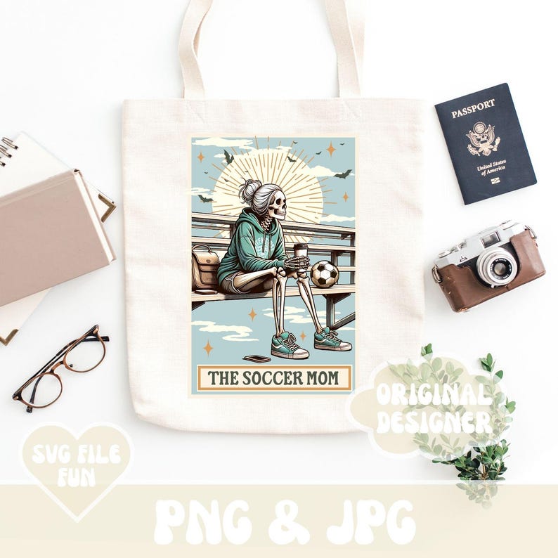 May include: A tote bag with a design of a skeleton wearing a blue shirt and holding a coffee cup. The text "The Soccer Mom" is printed on the bag.