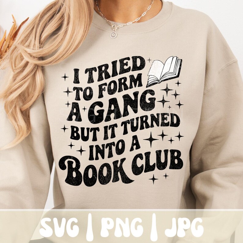 May include: Beige sweatshirt with the text "I tried to form a gang but it turned into a book club" in black. The design includes an open book graphic and star accents. The bottom of the image shows the file types: SVG, PNG, and JPG.