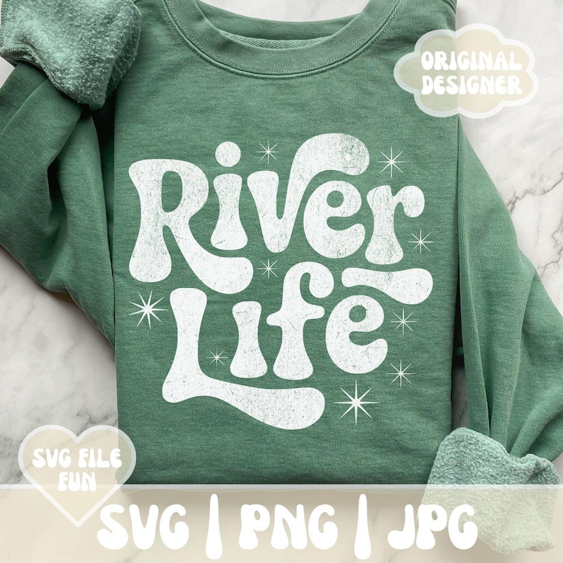May include: A sage green sweatshirt with the words "River Life" in a white, retro font. The design includes starburst accents. The words "SVG FILE FUN" and "ORIGINAL DESIGNER" are also visible.