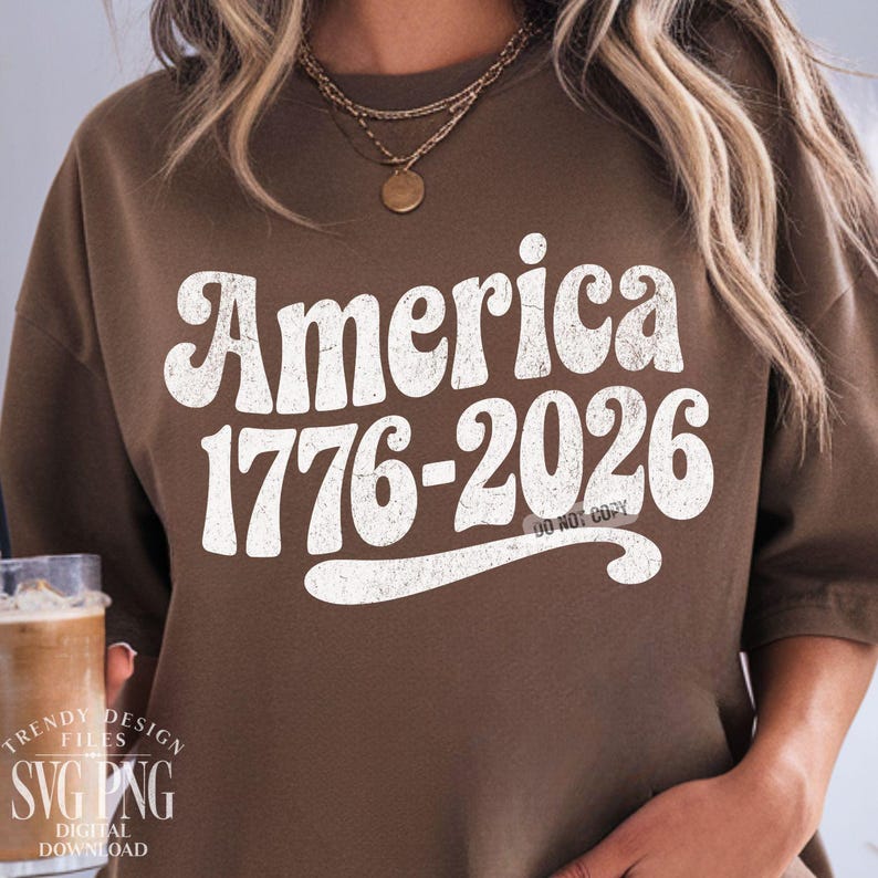 May include: A brown sweatshirt with the text "America 1776-2026" in a distressed white font. The sweatshirt also has the text "Do Not Copy" in a smaller font. The design is a vintage style.