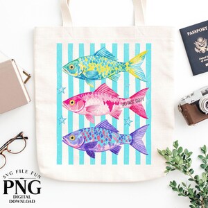 May include: A cream-colored tote bag featuring three colorful fish illustrations against a blue striped background. The fish are in shades of yellow, pink, and purple. The text "SVG FILE FUN PNG DIGITAL DOWNLOAD" is at the bottom.