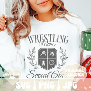 May include: White sweatshirt with a vintage-style design that says "Wrestling Moms Social Club" with a crest featuring wrestling-related icons. The text "Loud and Proud" is below the crest. The image also includes the words "SVG, PNG, JPG" and "Original Designer".