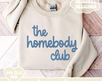 May include: A beige sweatshirt with the text "the homebody club" in blue lettering.