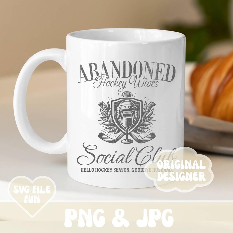 May include: White ceramic mug with a black and white graphic design that says "Abandoned Hockey Wives Social Club" with a hockey stick and helmet graphic. The text "Hello Hockey Season. Goodbye Husband" is below the graphic.