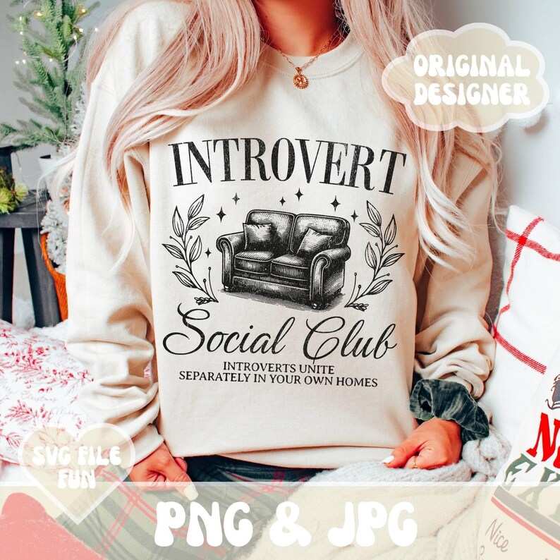 May include: A beige sweatshirt with the text "INTROVERT Social Club" and a black and white illustration of a couch. The text below the couch reads "INTROVERTS UNITE SEPARATELY IN YOUR OWN HOMES".