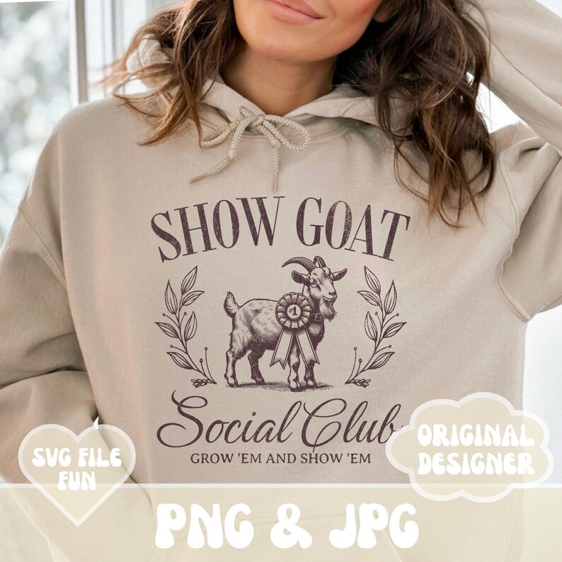 May include: A beige hoodie with a brown graphic of a goat wearing a ribbon that says "1" and the text "Show Goat Social Club Grow 'Em and Show 'Em" printed on the front.