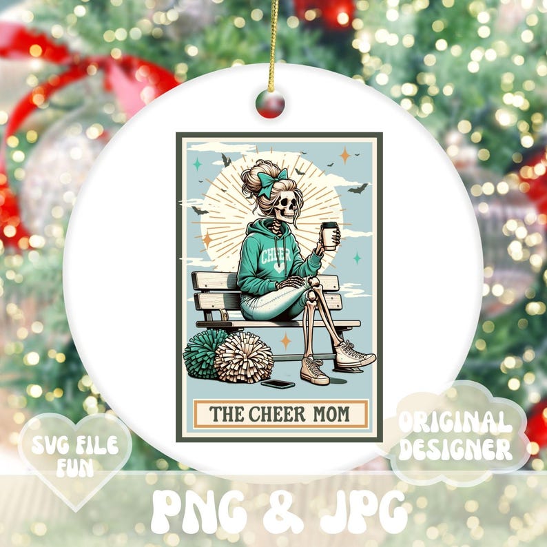 May include: A white ceramic ornament with a colorful illustration of a skeleton cheerleader holding a coffee cup. The text "The Cheer Mom" is printed below the image.