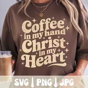 May include: A brown sweatshirt with the text "Coffee in my hand, Christ in my Heart" in a vintage font. The words are in a cream color with star accents. Below the text are the words "SVG | PNG | JPG".
