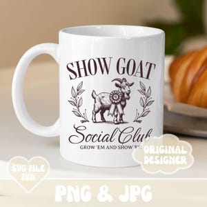 May include: White ceramic coffee mug with a black and white illustration of a goat with a ribbon. The text "SHOW GOAT Social Club GROW 'EM AND SHOW 'EM" is printed on the mug.