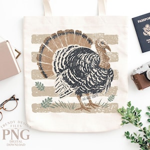 May include: A cream-colored canvas tote bag featuring a distressed graphic print of a turkey with brown and black feathers. The turkey stands on a background of horizontal beige stripes with small green leaf accents and the text DO NOT COPY.