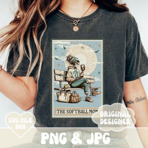 May include: A retro-style illustration of a skeleton wearing a softball jersey and sunglasses, sitting on a bench with a coffee cup and a bag. The text "The Softball Mom" is below the image.