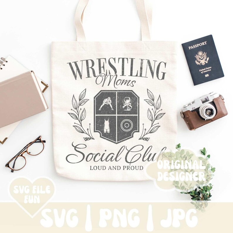 May include: A white tote bag with a black and grey design that says "Wrestling Moms Social Club Loud and Proud". The design features a crest with a wrestler, a weight, and a wrestling singlet.