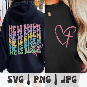 以下が含まれることがあります： 宗教的なデザインが施された黒いパーカー2枚。1枚は虹色のカラーリングで「He is Risen」の文字とハートと十字架が描かれている。もう1枚はハートの中に十字架が描かれている。