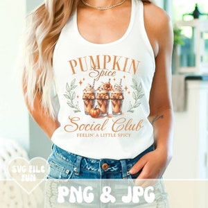 May include: White tank top with the text "PUMPKIN Spice Social Club" in orange. The graphic features three pumpkin spice lattes with whipped cream, a small pumpkin, and decorative leaves. The words "FEELIN' A LITTLE SPICY" are below the club name.