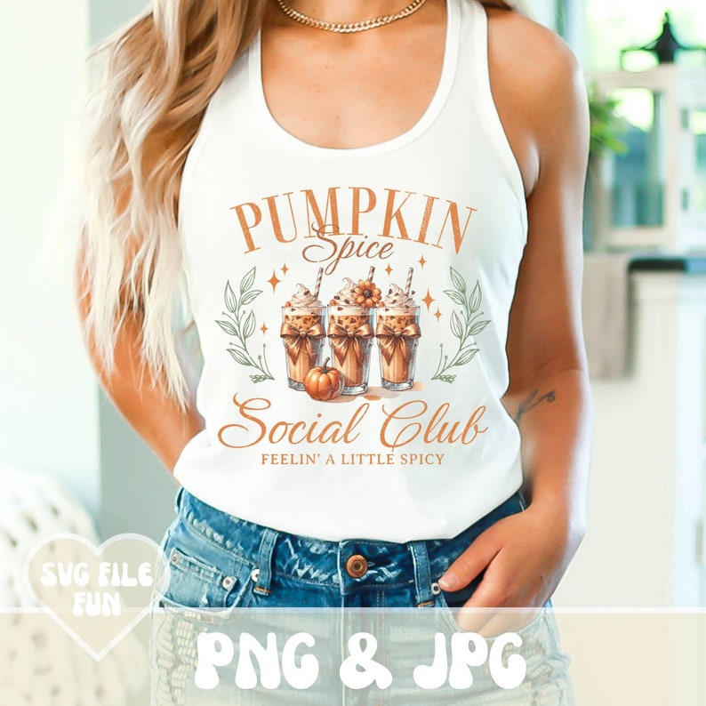 May include: White tank top with the text "PUMPKIN Spice Social Club" in orange. The graphic features three pumpkin spice lattes with whipped cream, a small pumpkin, and decorative leaves. The words "FEELIN' A LITTLE SPICY" are below the club name.