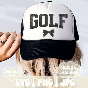 May include: A white trucker hat with a black mesh back. The front of the hat has the word "GOLF" in black with a black bow underneath.