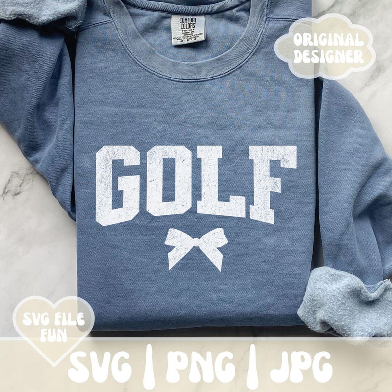 May include: A blue sweatshirt with the word "GOLF" in white distressed lettering and a white bow underneath. The sweatshirt is folded in half and has a white tag with the words "COMFORT COLORS" on it.
