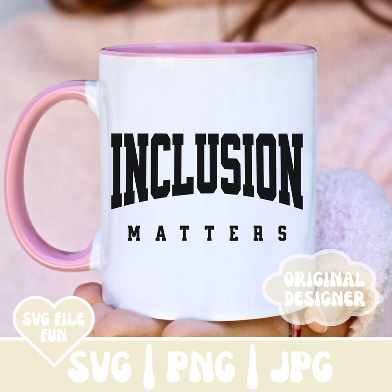 May include: A white ceramic mug with a pink rim and handle. The mug has black text that reads "INCLUSION MATTERS".
