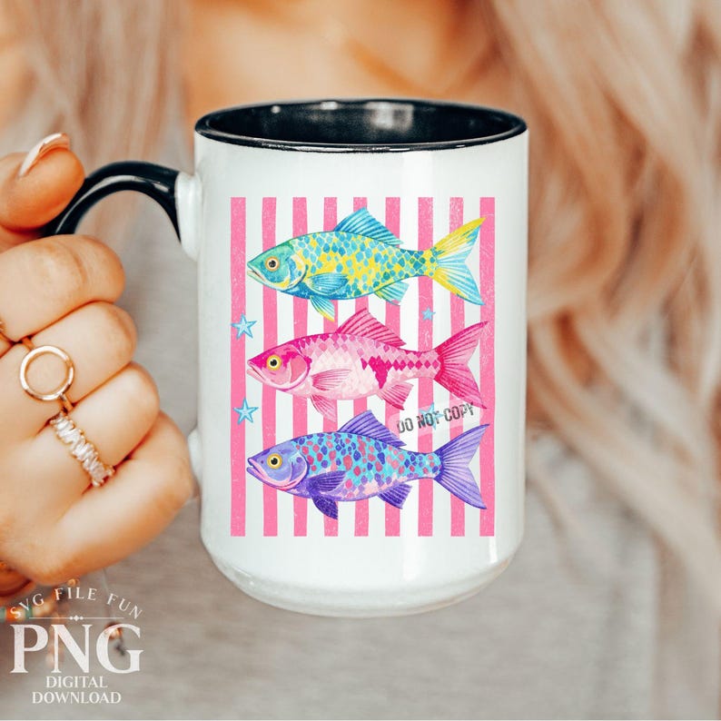 May include: White ceramic mug with a black handle and rim, featuring three colorful fish illustrations on a pink striped background. The fish are blue, pink, and yellow, with the text "DO NOT COPY" visible.