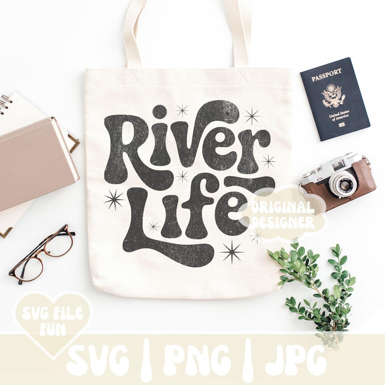 May include: Cream-colored tote bag with the words "River Life" in a retro font. The image includes a passport, a vintage camera, glasses, and a notebook. The words "SVG FILE FUN" and "SVG | PNG | JPG" are also visible.