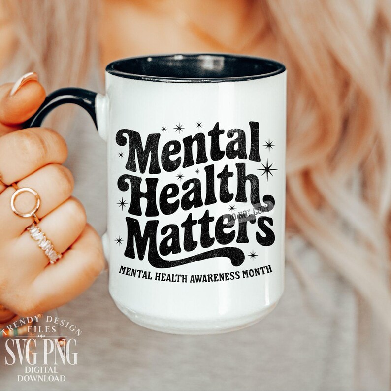 May include: White ceramic mug with a black interior and handle. The mug features the text "Mental Health Matters" in a bold, black font, with star accents. Below the text is "Mental Health Awareness Month".
