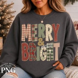 May include: A charcoal grey crewneck sweatshirt featuring the text MERRY & BRIGHT in large, block-style letters. Each letter displays a different pattern, including red and white gingham, green plaid, and floral prints in red, green, and cream.