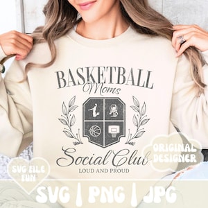 May include: A beige sweatshirt with a graphic design of a basketball crest with the text "Basketball Moms Social Club Loud and Proud" and the words "Original Designer" in a speech bubble.