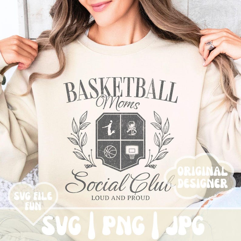 May include: A beige sweatshirt with a graphic design of a basketball crest with the text "Basketball Moms Social Club Loud and Proud" and the words "Original Designer" in a speech bubble.