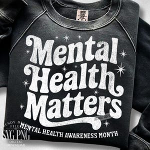 May include: Black sweatshirt with the words "Mental Health Matters" in white, along with starburst graphics. The phrase "Mental Health Awareness Month" is printed at the bottom. The sweatshirt has a Comfort Colors tag.