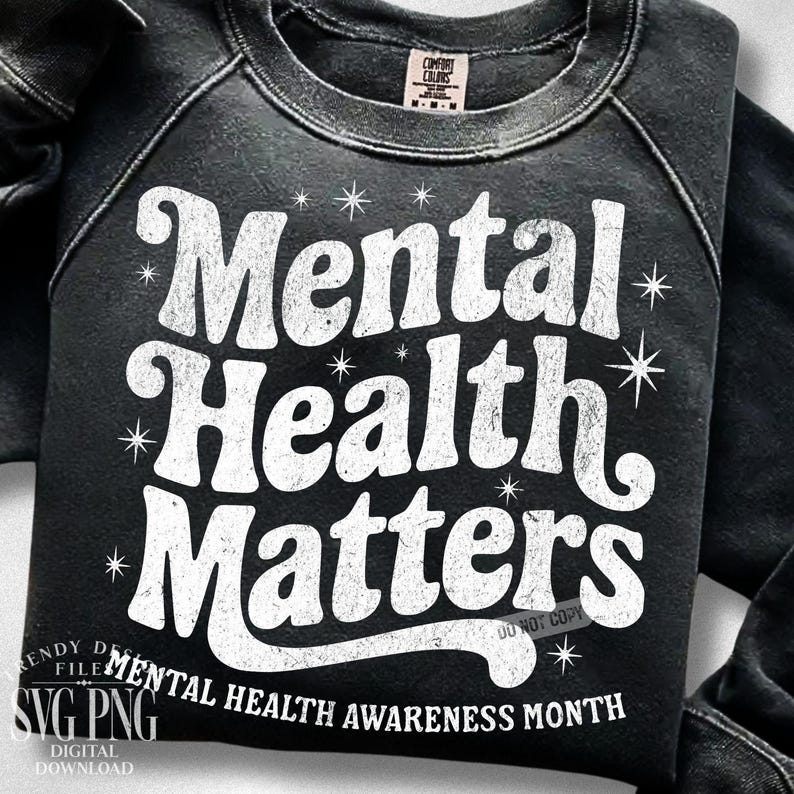 May include: Black sweatshirt with the words "Mental Health Matters" in white, along with starburst graphics. The phrase "Mental Health Awareness Month" is printed at the bottom. The sweatshirt has a Comfort Colors tag.