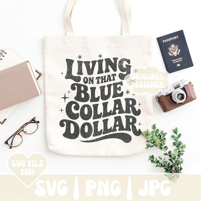 May include: Cream-colored tote bag with the text "Living on that Blue Collar Dollar" in a retro font. The image includes a passport, a vintage camera, glasses, and a small notebook. The design is available in SVG, PNG, and JPG formats.