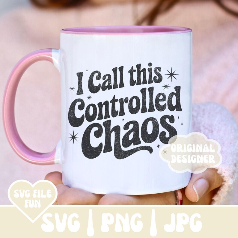 May include: White ceramic mug with a pink handle and interior. The mug features the text "I Call this Controlled Chaos" in a black, bold font. The design includes star accents. The mug also has the text "SVG FILE FUN" and "ORIGINAL DESIGNER".