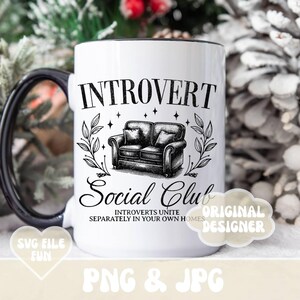 May include: White ceramic mug with a black handle. The mug has a black and white illustration of a couch and the text "Introvert Social Club Introverts Unite Separately in Your Own Homes" and "Original Designer".