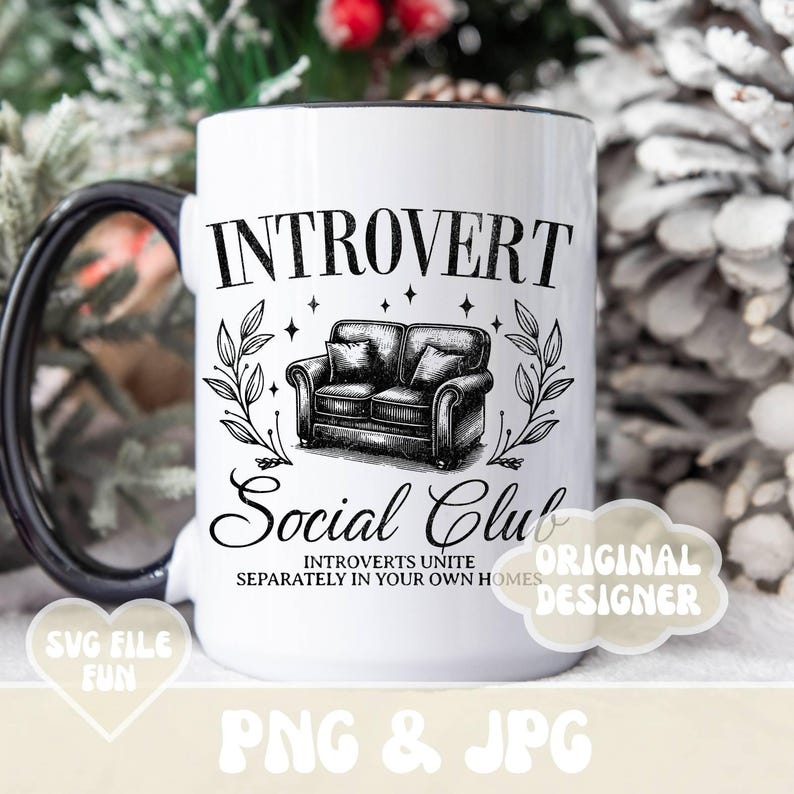 May include: White ceramic mug with a black handle. The mug has a black and white illustration of a couch and the text "Introvert Social Club Introverts Unite Separately in Your Own Homes" and "Original Designer".