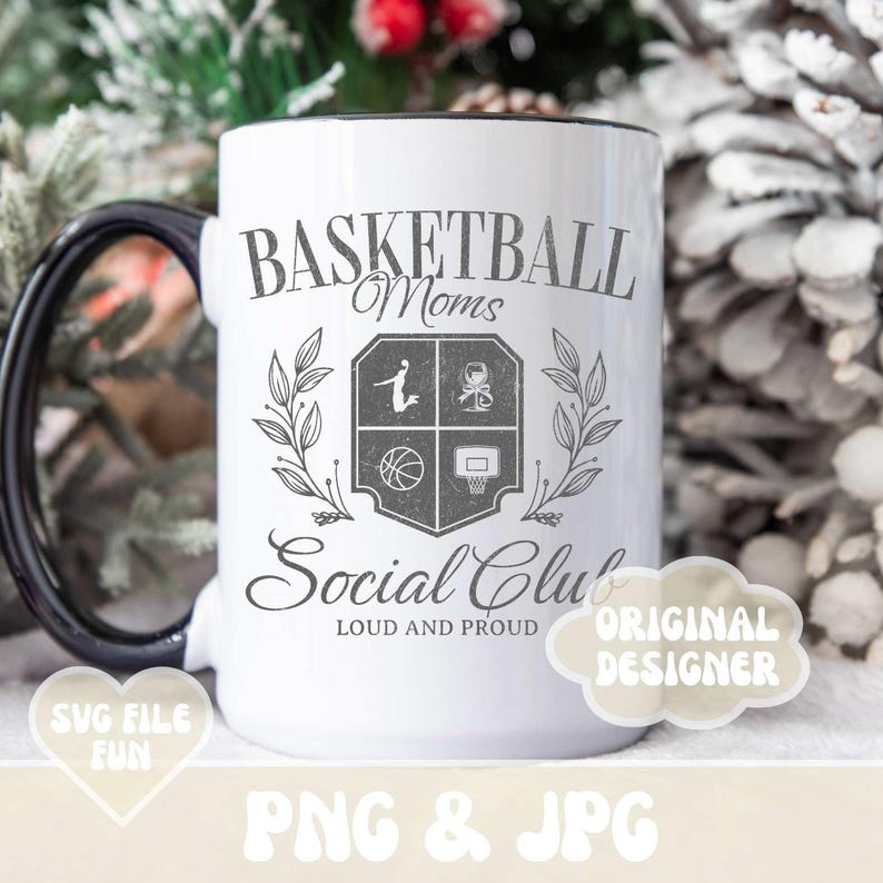 May include: White ceramic coffee mug with a black rim and handle. The mug features a black and white design of a basketball with the text "Basketball Moms Social Club Loud and Proud".