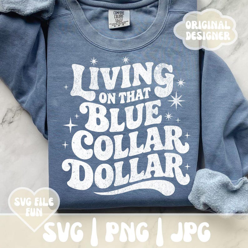 May include: A blue sweatshirt with the text "Living on that Blue Collar Dollar" in white, retro-style lettering. The design includes star accents. The sweatshirt has a crew neck and long sleeves.