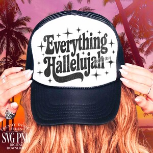 May include: Black and white trucker hat with the text "Everything Hallelujah" in a retro font. The hat has a white front panel and a black mesh back. The design includes star accents.