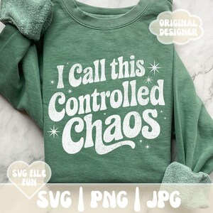 May include: A sage green sweatshirt with the phrase "I Call this Controlled Chaos" in white, retro-style lettering. The design includes starburst accents. The image also includes the text "SVG | PNG | JPG".