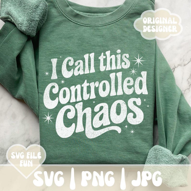 May include: A sage green sweatshirt with the phrase "I Call this Controlled Chaos" in white, retro-style lettering. The design includes starburst accents. The image also includes the text "SVG | PNG | JPG".