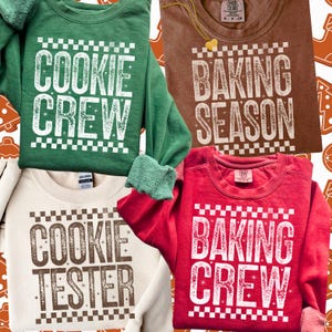 May include: Four crew neck sweatshirts in green, brown, cream, and red. Each shirt features white text with a checkerboard design. The green shirt says "COOKIE CREW", the brown shirt says "BAKING SEASON", the cream shirt says "COOKIE TESTER", and the red shirt says "BAKING CREW".