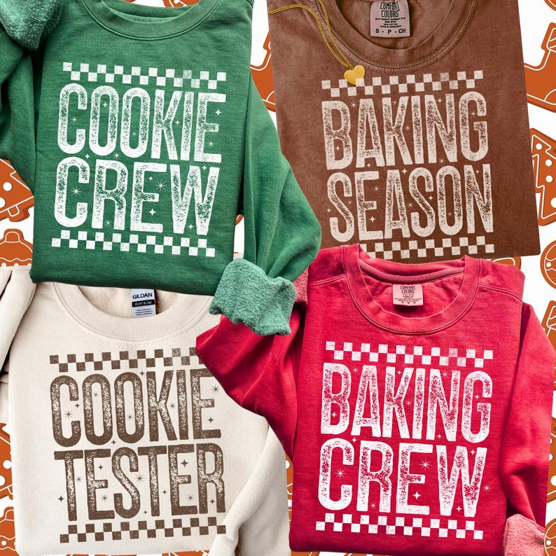 May include: Four crew neck sweatshirts in green, brown, cream, and red. Each shirt features white text with a checkerboard design. The green shirt says "COOKIE CREW", the brown shirt says "BAKING SEASON", the cream shirt says "COOKIE TESTER", and the red shirt says "BAKING CREW".