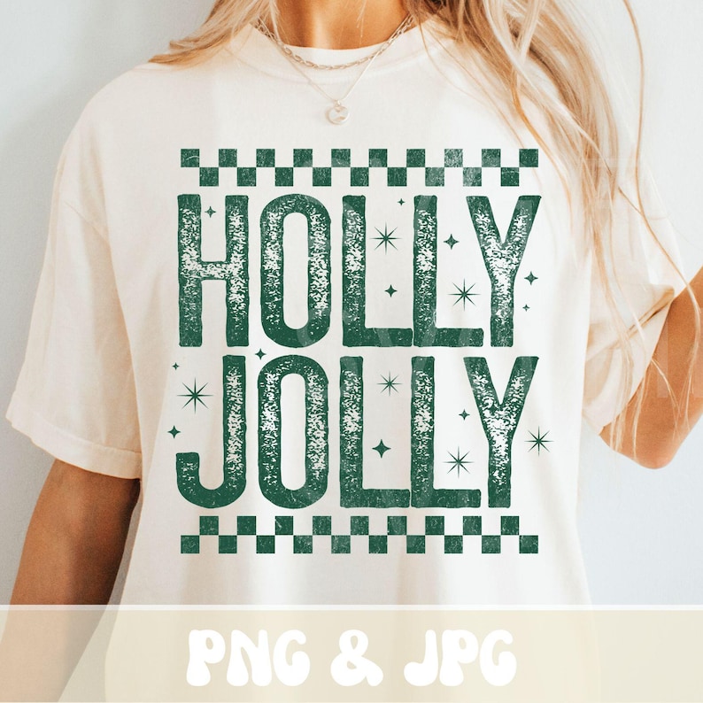 May include: A cream-coloured t-shirt featuring the words "HOLLY JOLLY" in distressed green lettering. The design includes a checkered border and star accents. The bottom of the shirt reads "PNG & JPG".