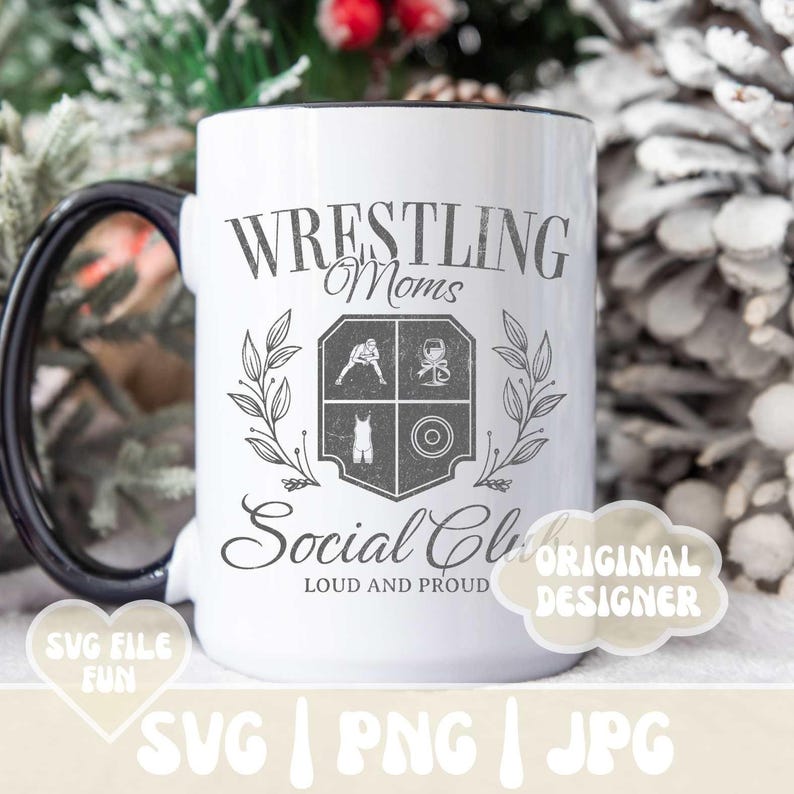 May include: White ceramic coffee mug with a black handle. The mug has a black rim and a design that says "Wrestling Moms Social Club Loud and Proud" with a crest featuring a wrestler, a weight, and a wine glass.