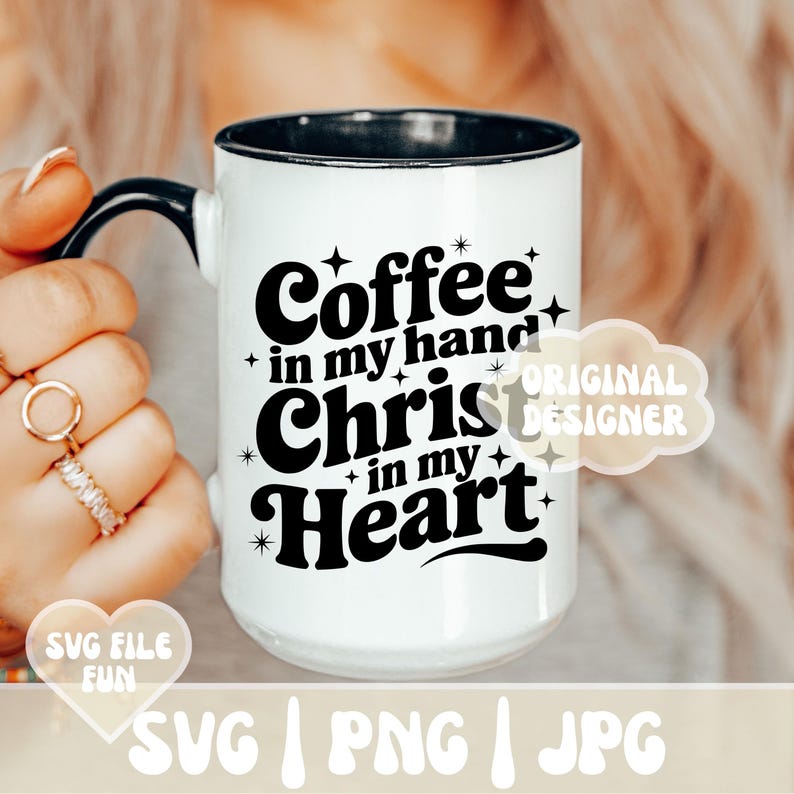 May include: White ceramic mug with a black handle and rim. The mug features the text "Coffee in my hand, Christ in my Heart" in a black, bold font. The design includes star accents.